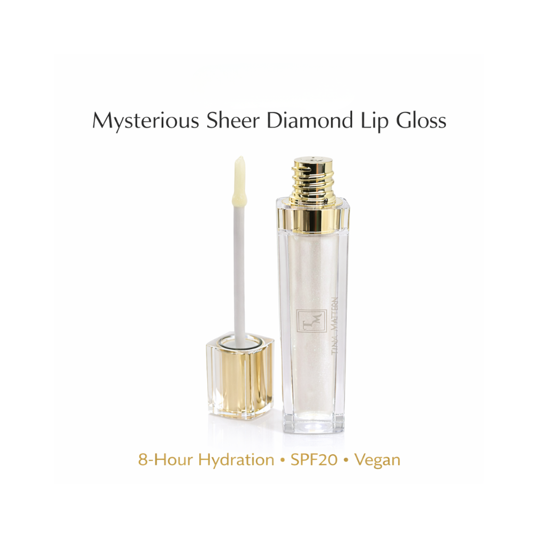 Tina Mattern Mysterious Sheer Diamond Moisturizing Lip Gloss with SPF 1 Tina Mattern Mysterious Sheer Diamond Lip Gloss hero image showing a clear lip gloss tube with gold cap and applicator on white background