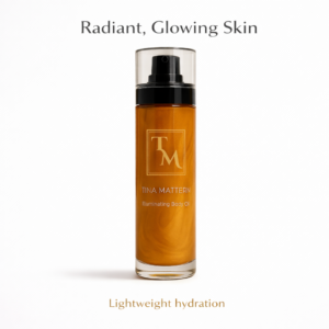 Tina Mattern Illuminating Body Oil in a clear pump bottle on a white background, lightweight shimmering body oil for radiant glowing skin
