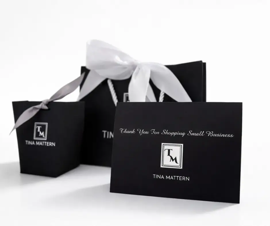Tina Mattern custom gift packaging with black gift bags and thank you card