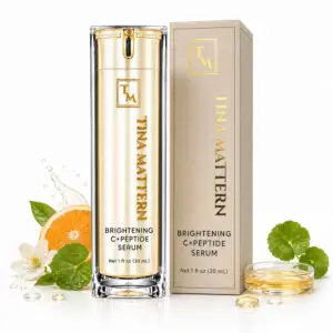 Tina Mattern Brightening C+ Peptide Serum in a gold pump bottle beside its coordinating product box with botanical accents.